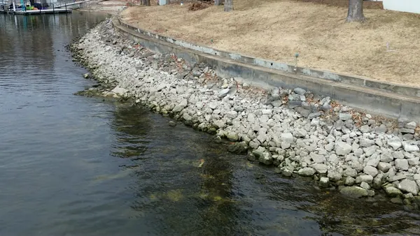 Completed rip rap shoreline protecting a lawn