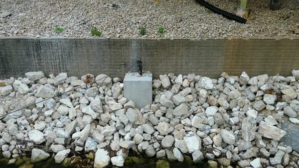 White rock rip rap set against a retaining wall